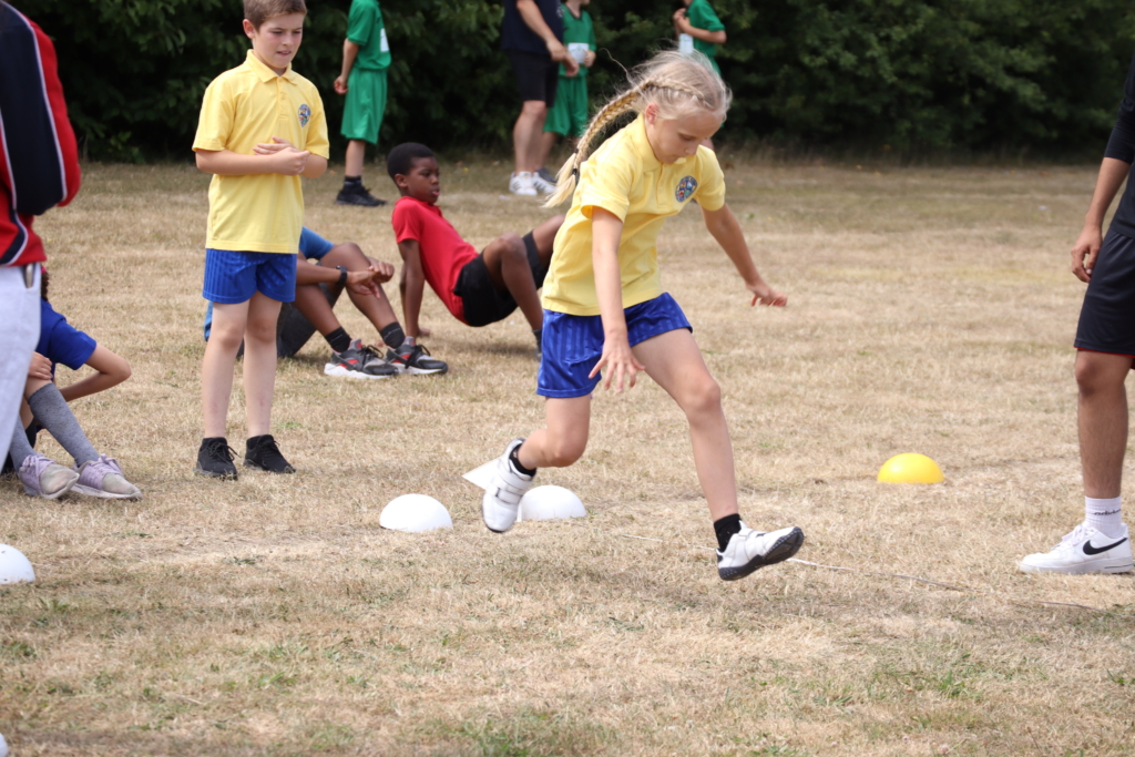 trust sports day at aletheia academies trust with horton kirby doing long jump